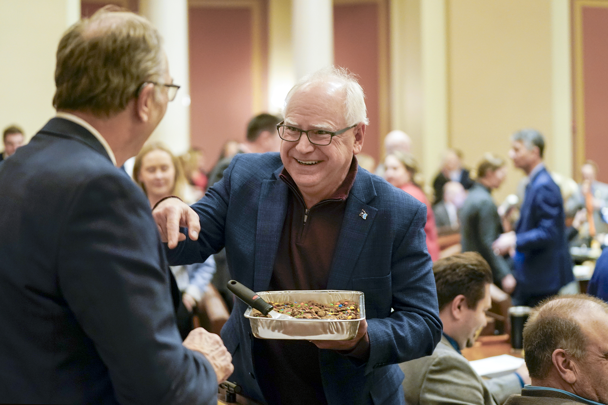 Gov. Tim Walz hands out bars to Rep. Paul Torkelson before the Feb. 10 floor session. This week marked the first full week of the 2025 session with both DFL and Republican members in attendance. (Photo by Michele Jokinen)